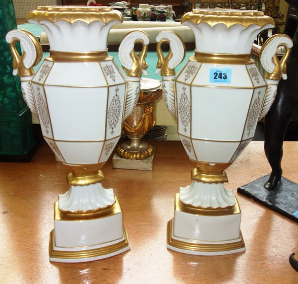 A pair of Continental white glaze twin handled vases, with gilt decoration and swan's head handles, (2).