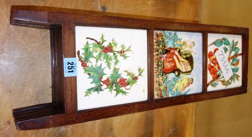 A 20th century small three fold screen with twelve inset ceramic tiles depicting figures and plants,  (a.f)