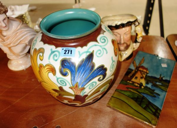 A large Royal Gouda style type vase, a Doulton jug modelled as Henry VIII and a tile depicting a windmill, (3).