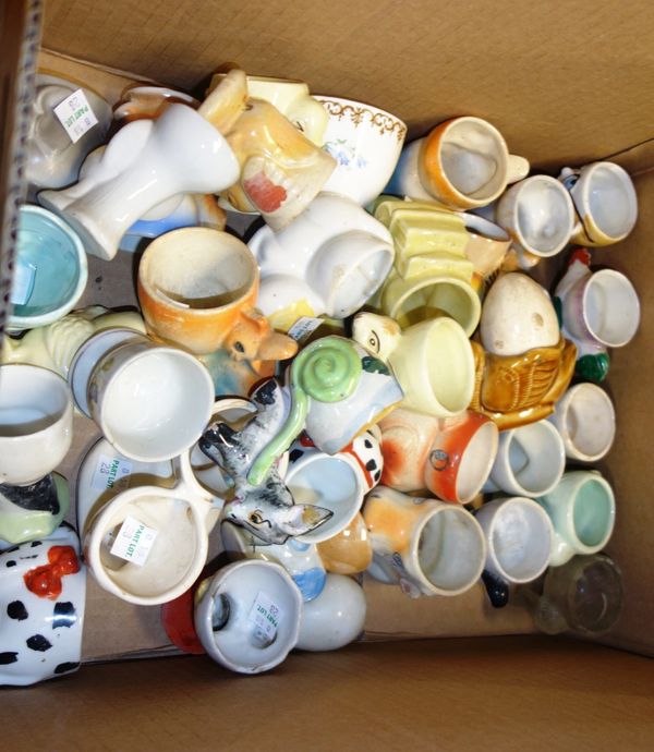 A large quantity of 20th century novelty egg cups, (qty).