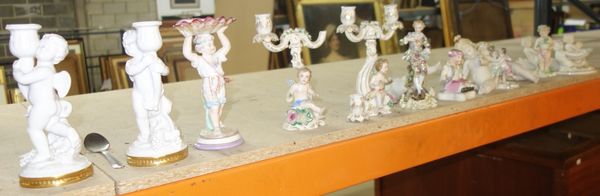 A quantity of ceramic figures mainly Continental including a pair of figural twin branch candelabra, assorted figures depicting putto and sundry, (2).