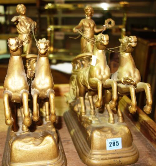 A pair of 20th century gilt metal horse and chariot figures, (2).