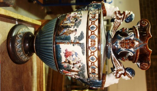A large German majolica twin handled vase moulded with figures.