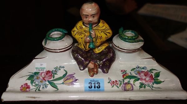 A late 19th /early 20th century French faience encrier, with central figure of a seated snake charmer modelled as a Chinaman, 27cm wide; and a mid-20t