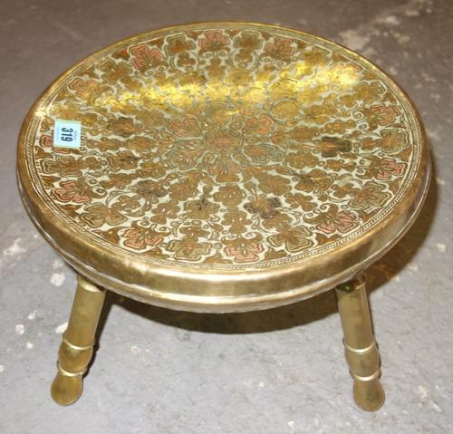 A pair of Middle Eastern three legged stools with brass and enamel decoration, (2).