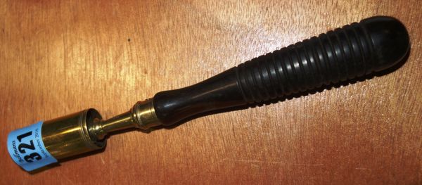 A 19th century brass and lignum vitae 12 bore shotgun cleaner with removable cap, 20cm long.