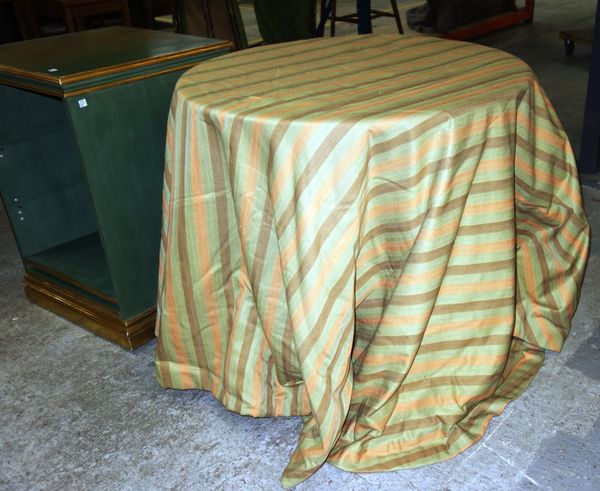 A modern circular occasional table with striped fabric loose covers, 85cm wide, together with a green painted parcel gilt floor standing bookcase, 54c