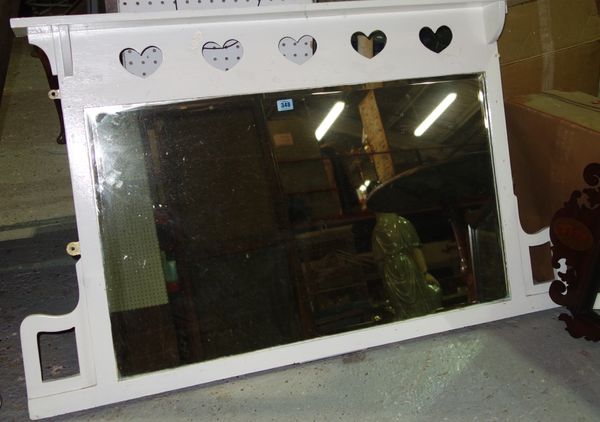 A 20th century white painted overmantel mirror with bevelled plate and pierced heart motifs.