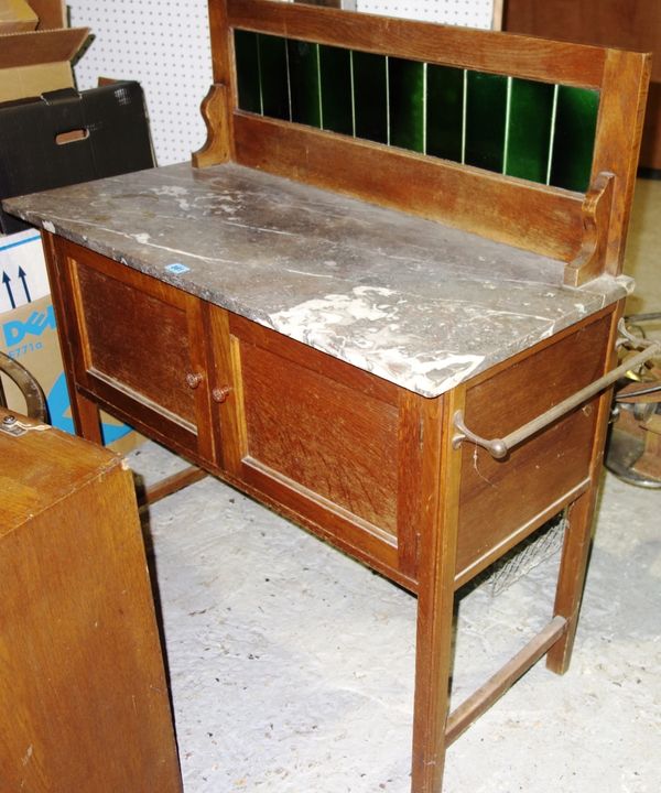 A 20th century oak marble top wash stand with tiled back, 87cm wide.