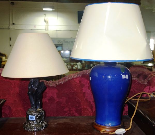 A 20th century table lamp formed as a seated sphinx, on turned marble base (a.f), together with a blue glazed baluster table lamp. (2)