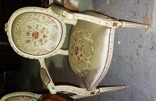 A set of three 20th century cream and gilt painted upholstered fauteuils.