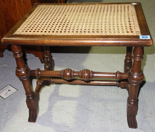 A 19th century walnut and cane stool.
