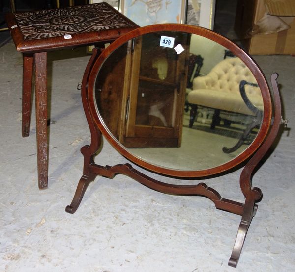 A 20th century oak occasional table and a swing frame mirror, (2).