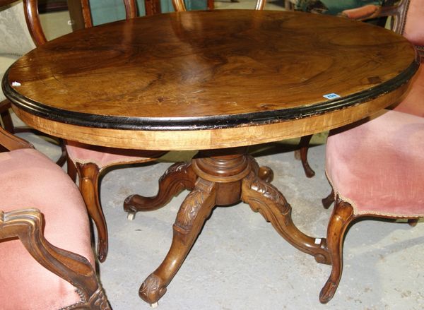 A Victorian walnut oval top loo table, on carved base, 118cm wide.