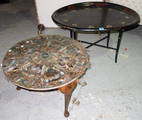 A black lacquer floral painted oval tray on stand and a small occasional table decorated with feathers.
