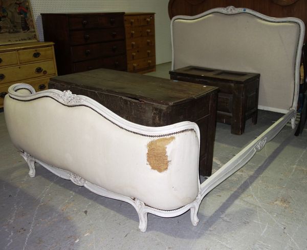 A 20th century white painted upholstered bed.