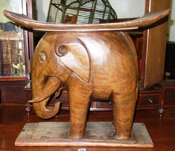 A 20th century Ashanti type stool with elephant decoration.