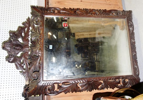 A large early 20th century carved oak wall mirror.