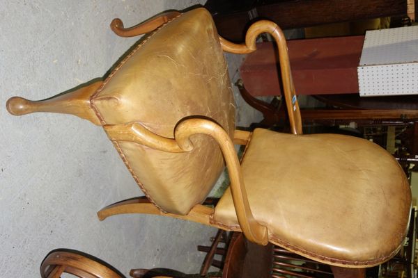 A 19th century walnut and leather upholstered office chair.