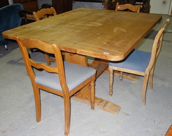 A pine small refectory table and four beech ladder back dining chairs.