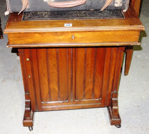 A Victorian walnut framed Davenport, the slope top over pedestal cupboard, 60cm wide.
