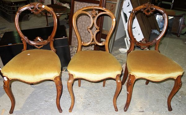 A pair of Victorian walnut carved balloon back dining chairs, together with another similar. (3)
