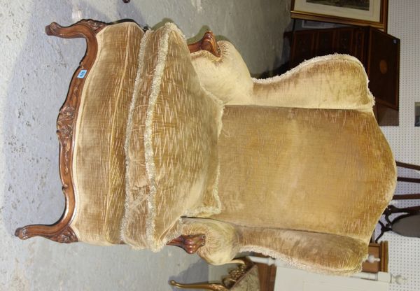 A 19th century walnut framed wing back armchair.