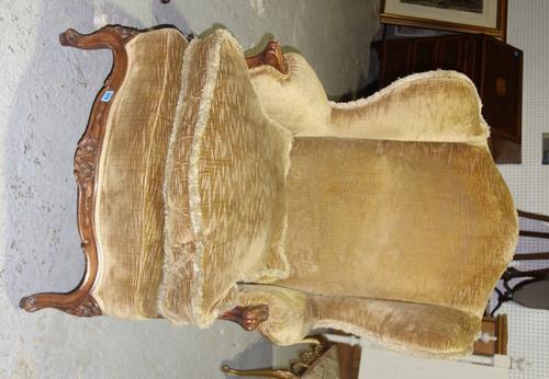 A 19th century walnut framed wing back armchair.
