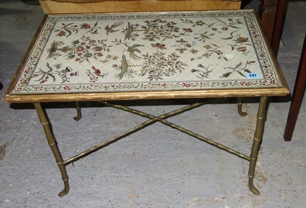 A brass coffee table with tapestry inset top.