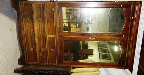 An Edwardian mahogany and satinwood banded linen press with mirrored doors.