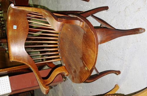 A 19th century oak spindle back open armchair.