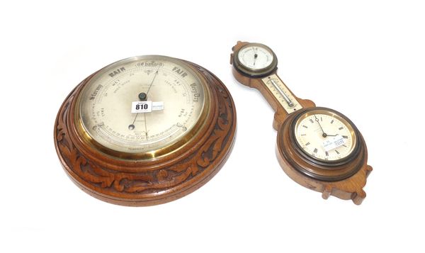 A circular walnut carved wall barometer compendium by 'Jas Pithial London' with subsidiary thermometer (30cm diameter) and a French oak cased wall clo