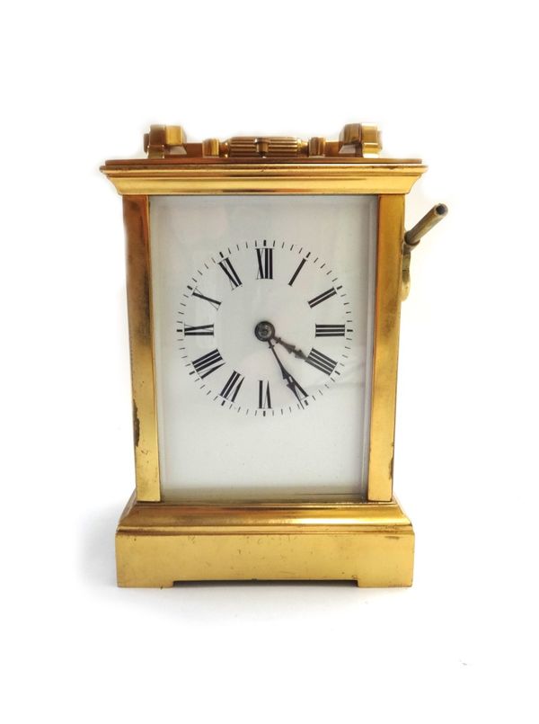 A gilt brass cased carriage clock, 19th century, hour repeat chiming on a gong, with a two train movement, white enamel dial and a fold over angular h