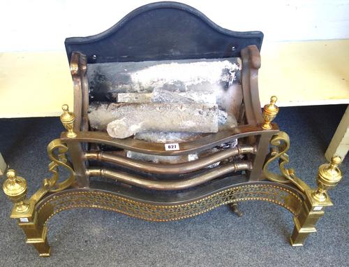 An 18th century style steel and brass fire basket, with pierced serpentine front and urn finials, 78cm wide.