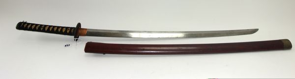 A Japanese katana, late 19th century, with polished steel blade 74cm, circular pierced iron tsuba, cord bound fish skin handle in a wooden saya. (a.f)