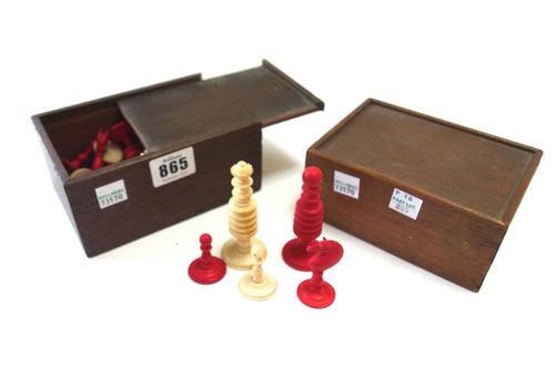 A stained ivory chess set, 19th century, of turned form, the king 8cm high, and another 19th century stained ivory chess set of similar turned form, t