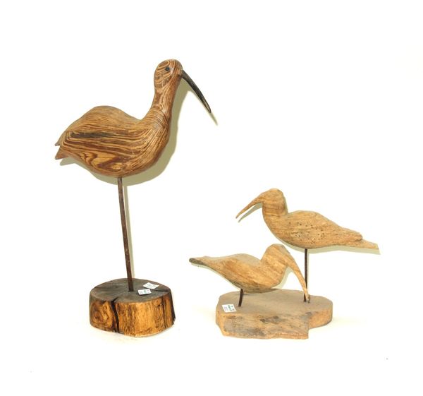 Two polychrome painted decoy ducks, circa 1930, papier mâché and pine, 34cm wide, a painted cast iron duck, a painted sheet metal weather vane finial,