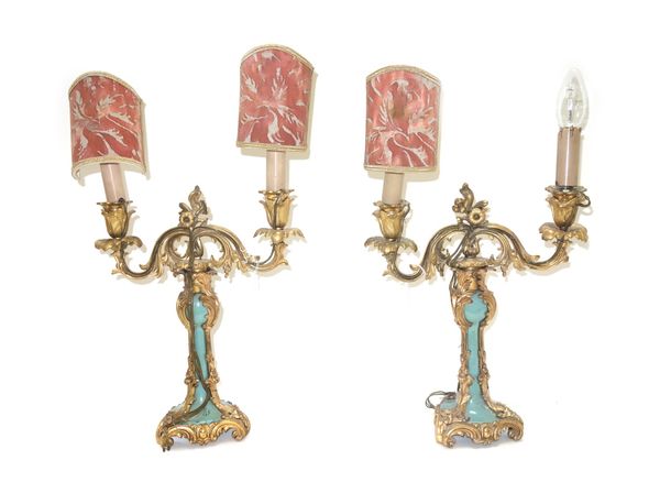 A pair of ormolu and green glazed twin light candelabra, 19th century, (a.f), 34cm high excluding fitments. (2)