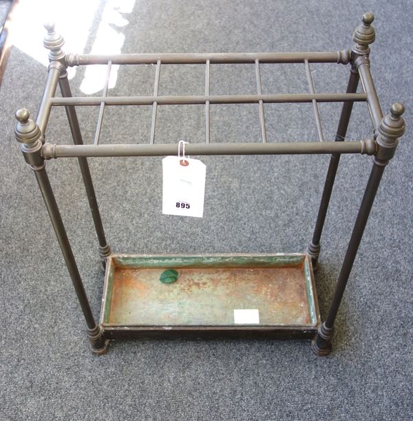 A Victorian tubular brass twelve division stick stand, of rectangular form, with turned finials and a metal drip tray, 64.5cm high x 50cm wide x 23.5c