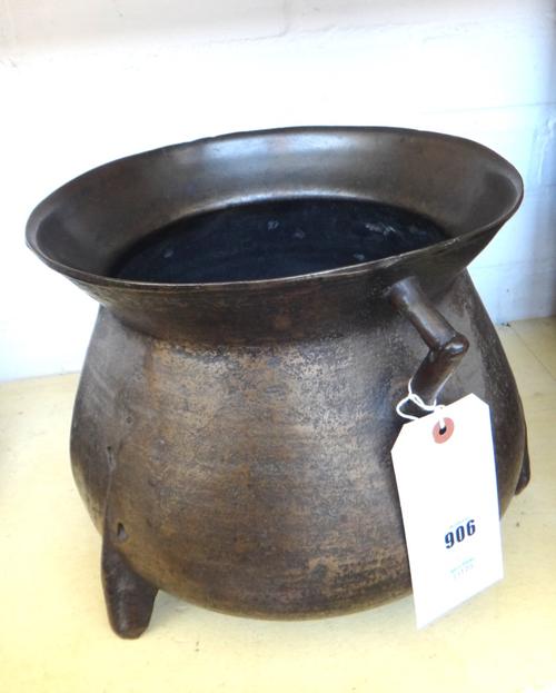 A bronze two handled cauldron, probably 18th century, raised on three feet 24cm high and a Victorian cast iron boot scraper 37cm wide. (2)