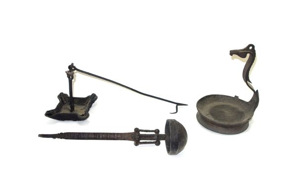An 18th century iron hanging oil lamp, together with an 18th century wrought iron door escutcheon, a 17th century iron latch, a 19th century brass han