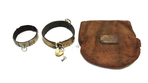 A Victorian brass bound dog's collar, with padlock and key, 3.5cm wide, together with a smaller studded metal and leather dog's collar engraved 'Raoul