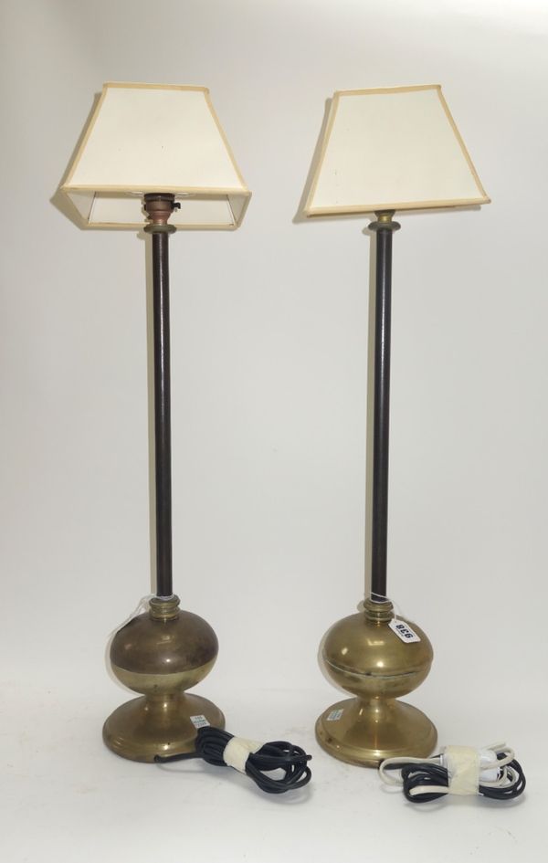 A pair of Victorian bronze table lamps, each with a plain iron stem and bulbous turned base, 58cm high excluding fitments. (2)
