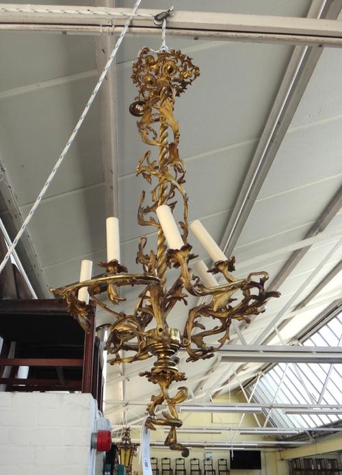 A French ormolu six light chandelier, late 19th century, the spiral twist stem issuing parallel spiral twist foliate scroll and three branches each wi