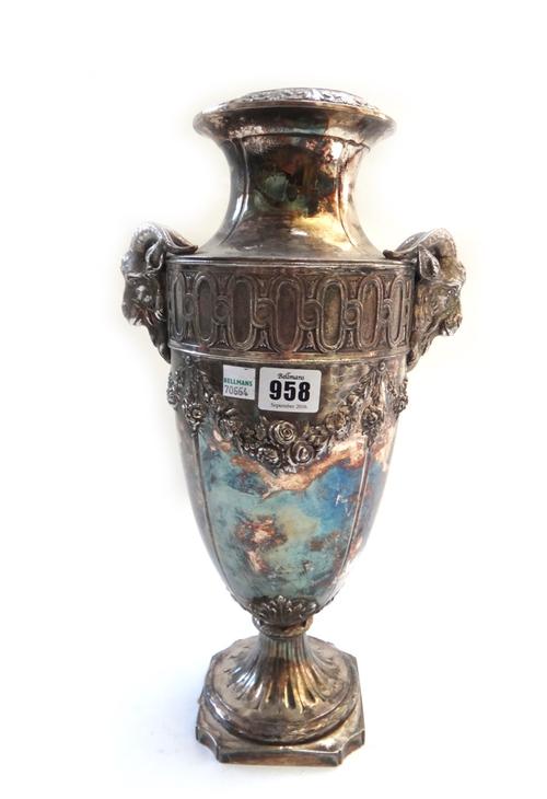A set of four modern white metal urns, each cast with rams head handles and foliate swags over a tapering body and canted square foot, 39.5cm high. (4