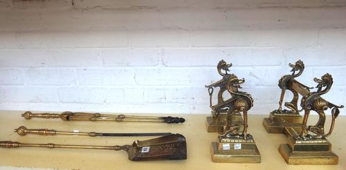 A set of three Victorian brass fire irons with poker work decoration to the handles, and a pair of brass tool rests with anthropomorphic cast decorati