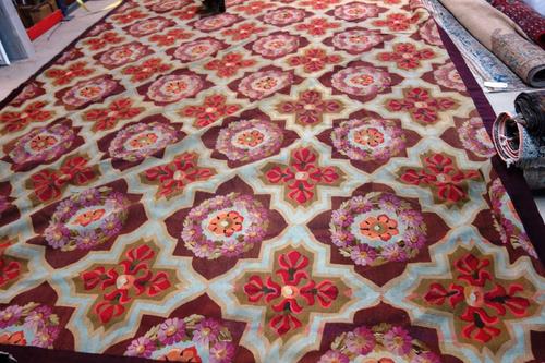 A large Aubusson carpet, the interconnecting design with floral cartouches and crosses motifs, 604cm x 315cm.  SN00538912/001