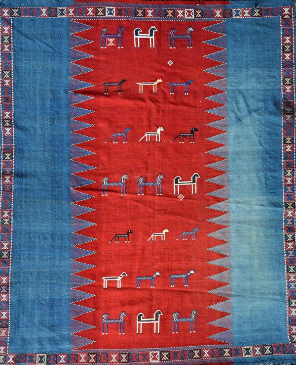 An Uzbekistan flatweave panel, the central madder panel with rows of horses, goats, dogs, supportive indigo side panels, 198 x 160cm. Illustrated