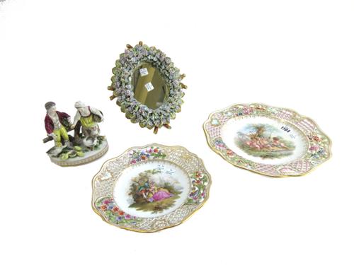 A Dresden porcelain cabinet plate, 20th century, decorated with a putti fishing group within a foliate pierced wide border, 28cm diameter, one similar