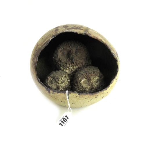 Catharni Stern; an unusual stoneware sculpture modelled with a family group of three owls sheltering within an egg shaped body, incised to base and da